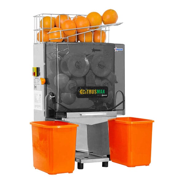An Omcan automatic stainless steel juice extractor with oranges in it.
