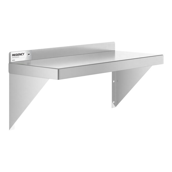 A metal wall-mounted shelf with two triangular support brackets and a small label on the left side.