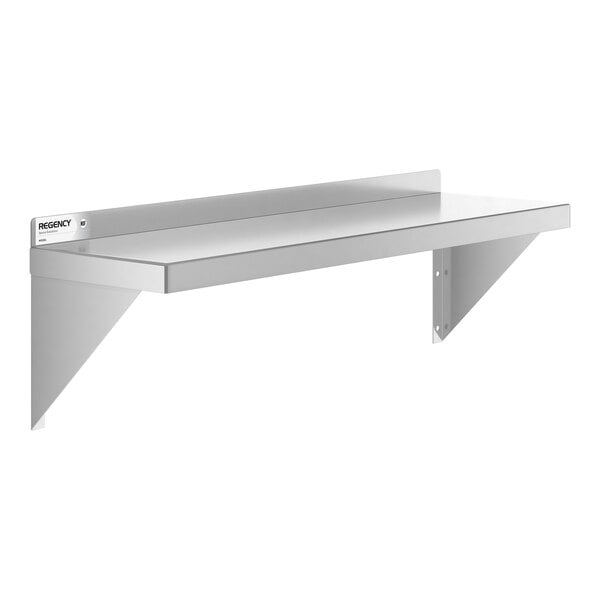 A metal wall-mounted shelf with a flat surface, a raised back edge, and two triangular support brackets.