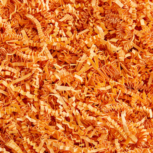A pile of Spring-Fill Cognac Crinkle Cut paper shred.