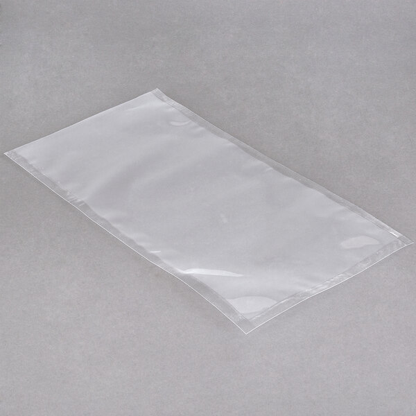 An ARY VacMaster clear plastic vacuum packaging bag on a gray surface.