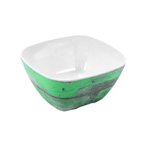 A Dalebrook Rustic Teal Melamine Crock with a white center and rim.