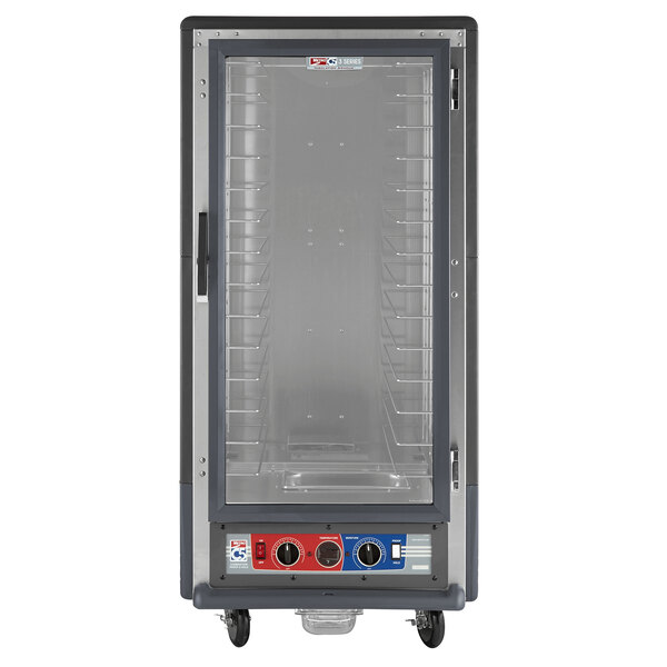 A grey Metro C5 holding and proofing cabinet with a clear glass door and shelves.