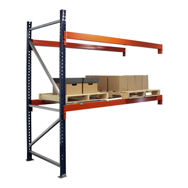 A blue and orange Interlake Mecalux heavy-duty bolted pallet rack with metal shelves holding boxes.