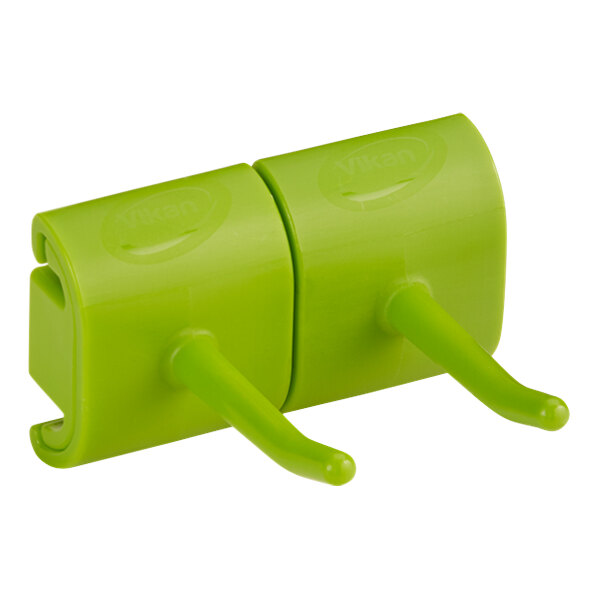 A white Vikan wall bracket with two lime green plastic hooks.