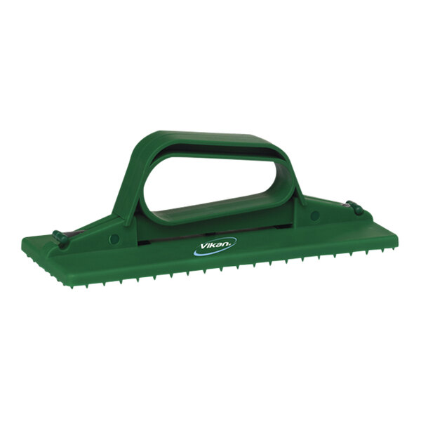 A Vikan green plastic handheld scrub pad holder.