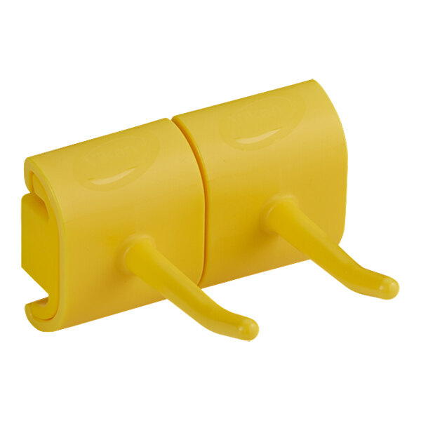 A yellow plastic Vikan double hook bracket.