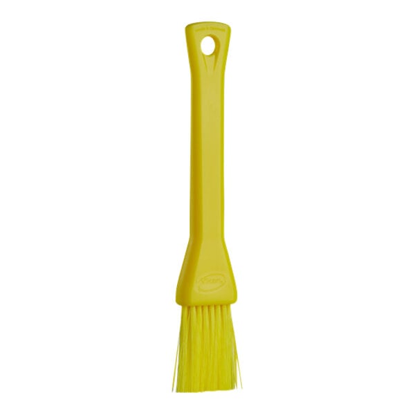 A yellow Vikan pastry brush with a plastic handle.