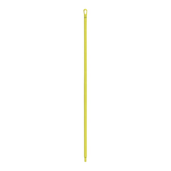 A yellow plastic stick with a hole.