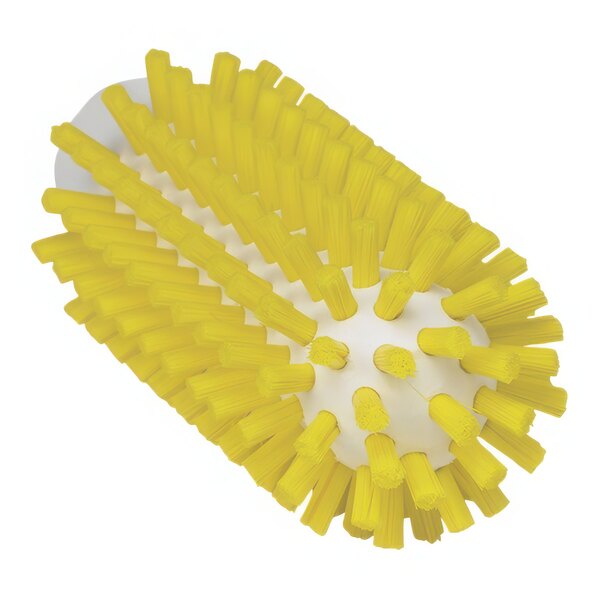 A close up of a yellow Vikan tube brush head with stiff white bristles.