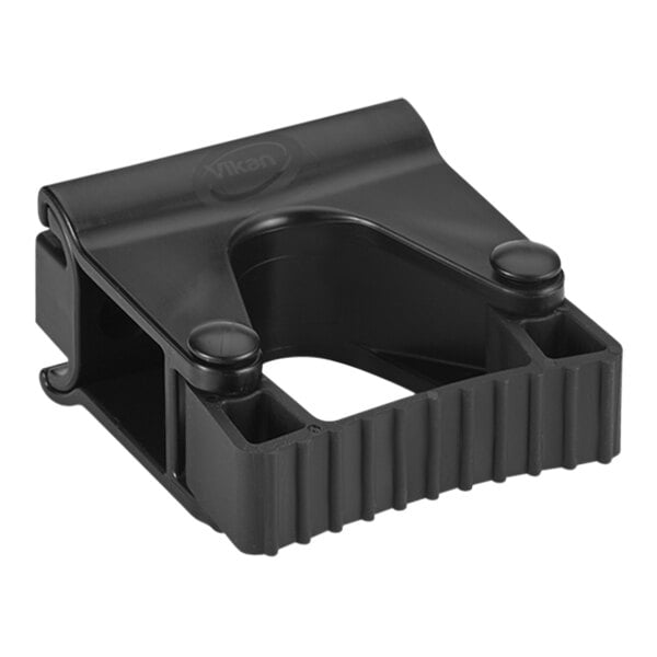 A black plastic Vikan wall bracket with two holes.