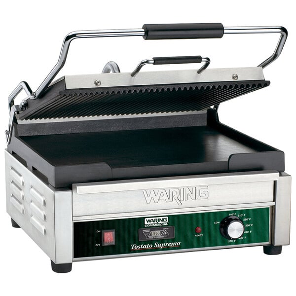 A Waring panini grill with a green and black handle.