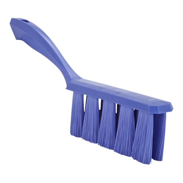 A blue brush with long bristles and a blue plastic handle.