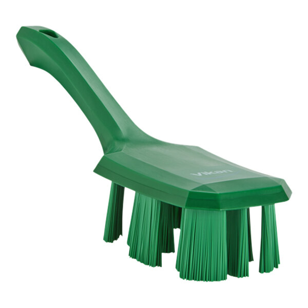 A green Vikan hand brush with stiff bristles.