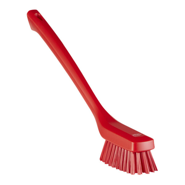 A red plastic brush with a handle.