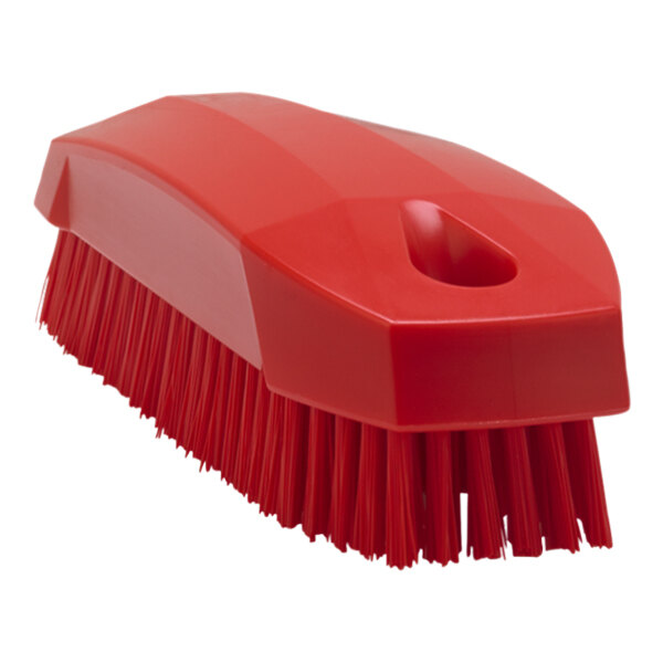 A close-up of a red Vikan hand brush with a hole in the handle.