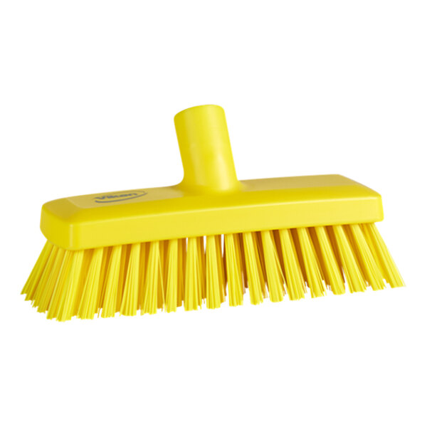 A close-up of a Vikan yellow wall/deck scrub brush head with stiff bristles.