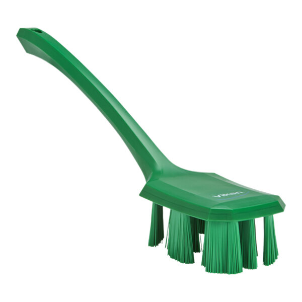 A green Vikan hand brush with long handle.