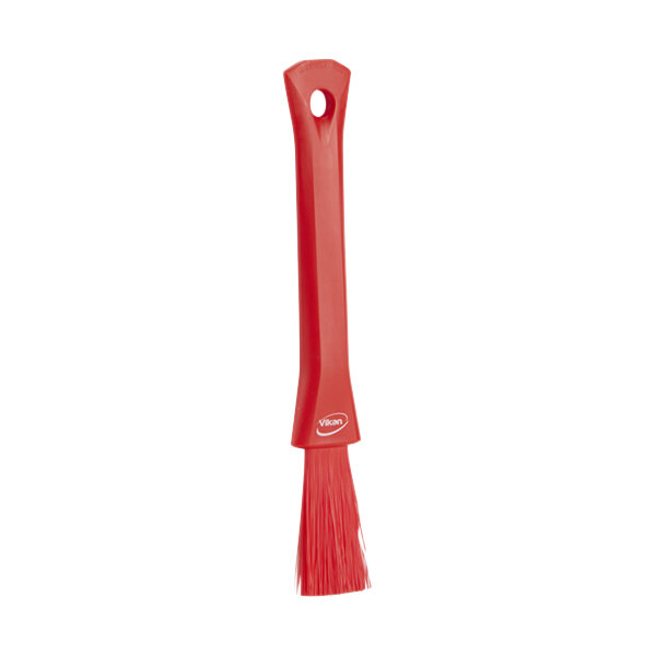 A red brush with a handle.
