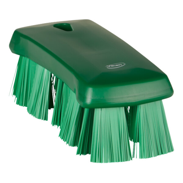 A green Vikan hand brush with stiff bristles.