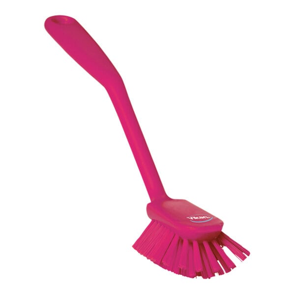 A Vikan pink dish brush with a long handle.