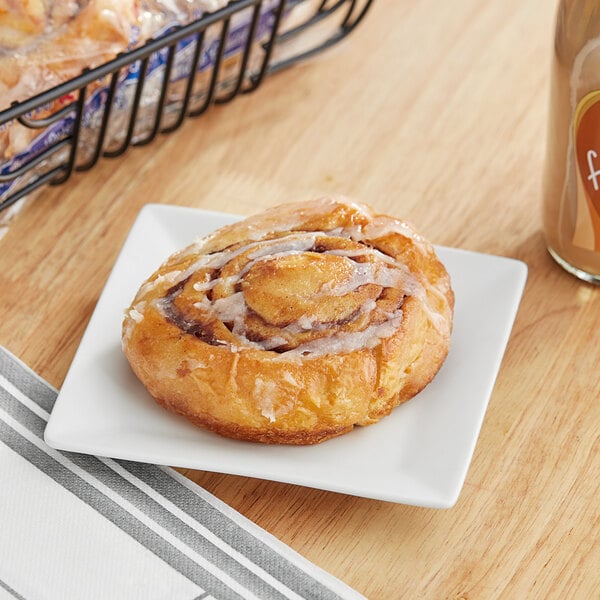 A Ne-Mo's Bakery frozen cinnamon roll on a plate.