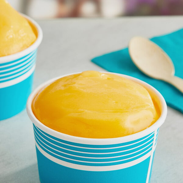 A cup of yellow Philadelphia Water Ice mango Italian ice.