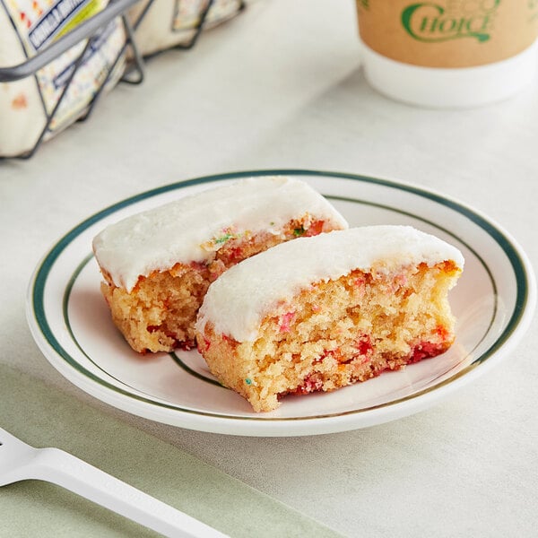 A plate with two Ne-Mo's Bakery vanilla birthday cake squares on it.