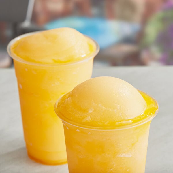 Two cups of Philadelphia Water Ice orange Italian ice.