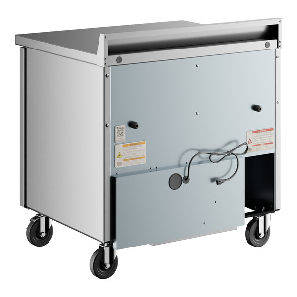 A large metal True worktop refrigerator with wheels.