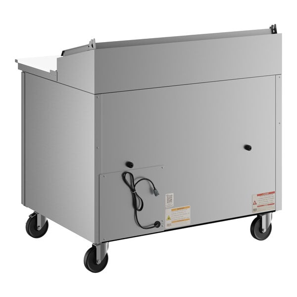 A stainless steel refrigerated pizza prep table with one door, mounted on four caster wheels.