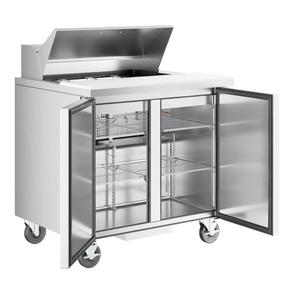 A stainless steel True refrigerated sandwich prep table with two doors.