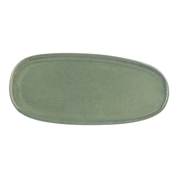 A close-up of a Front of the House Artefact moss green oval porcelain plate.