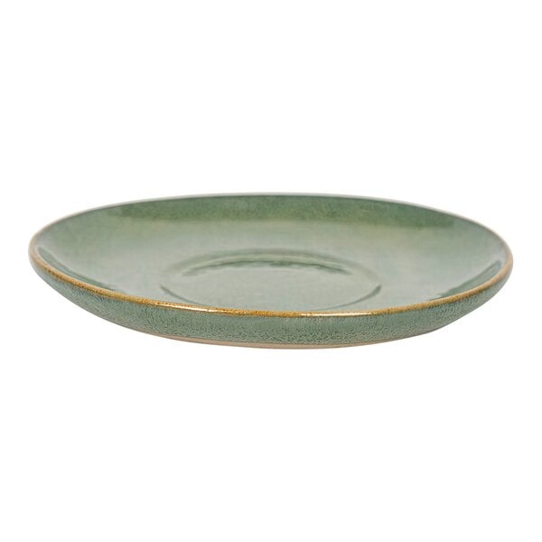 A close up of a Front of the House Artefact moss porcelain saucer with a gold rim.