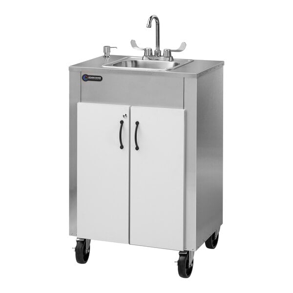 An Ozark River Manufacturing stainless steel portable hot water hand sink with a white cabinet on wheels.