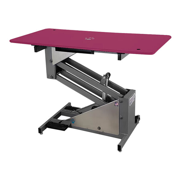 A pink grooming table with a silver frame and wheels.