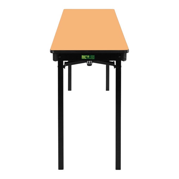 A National Public Seating rectangular folding table with a light brown top and T-mold edges.