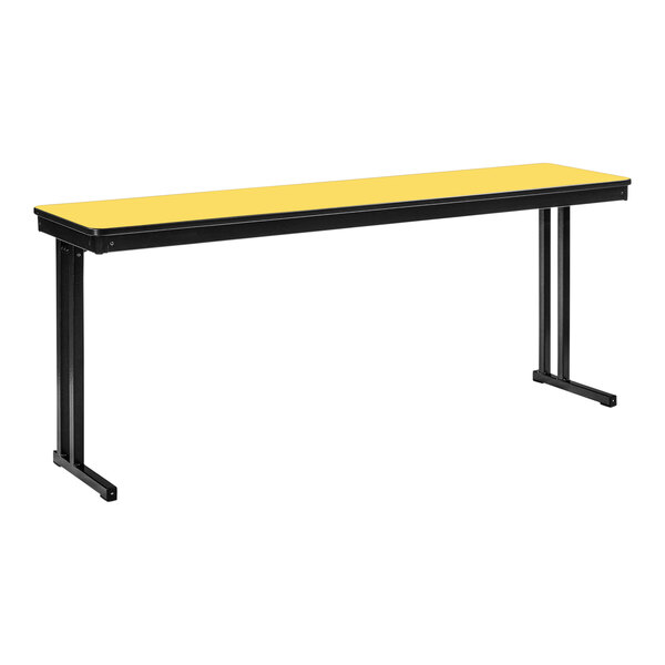 A yellow rectangular table with black legs.