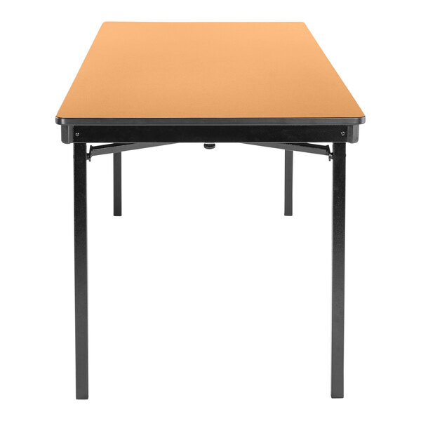 A National Public Seating Fusion Maple rectangular table with black legs.