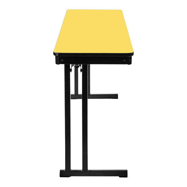 A yellow National Public Seating rectangular folding table with black edges and cantilever legs.