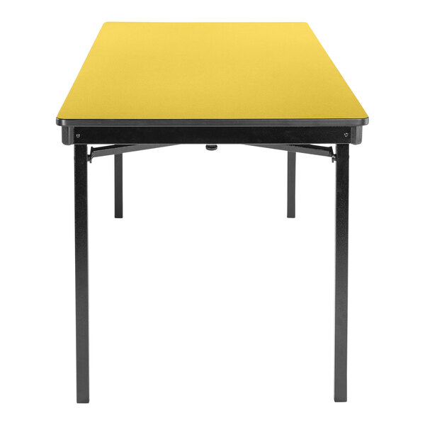 A National Public Seating marigold rectangular table with black legs.