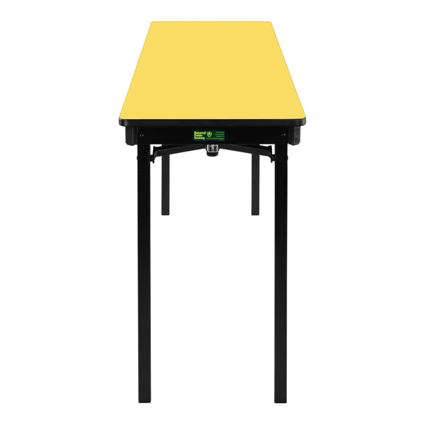 A yellow rectangular National Public Seating table with black edges and legs.