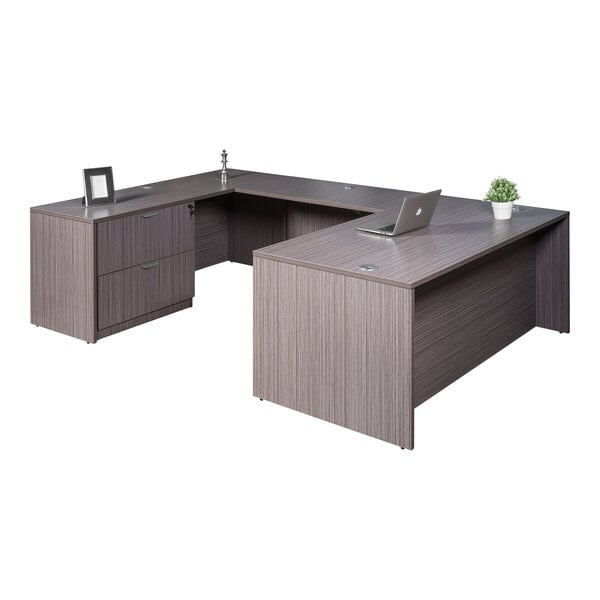 A Boss Holland laminate desk with a laptop and plant on it.