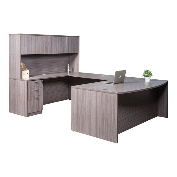 A Boss Holland driftwood laminate desk with storage pedestal.