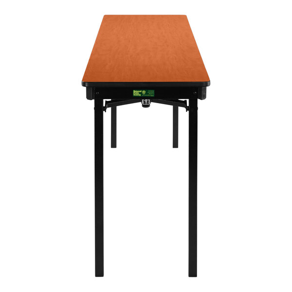 A National Public Seating rectangular table with a T-mold edge and a wild cherry top.