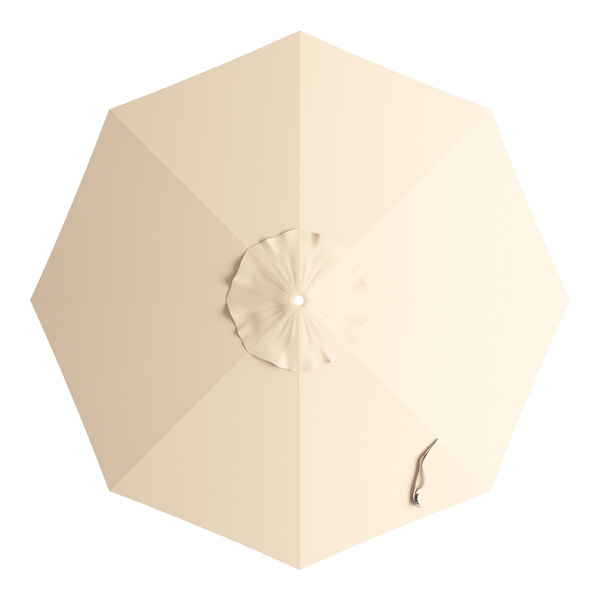 A beige umbrella with a hole in the center.