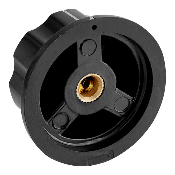 A black plastic circular knob with a gold center.