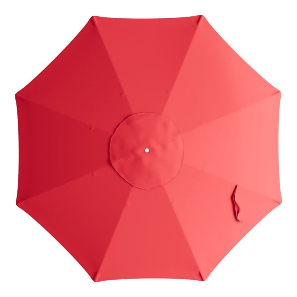 A red umbrella canopy with a white circle in the center.