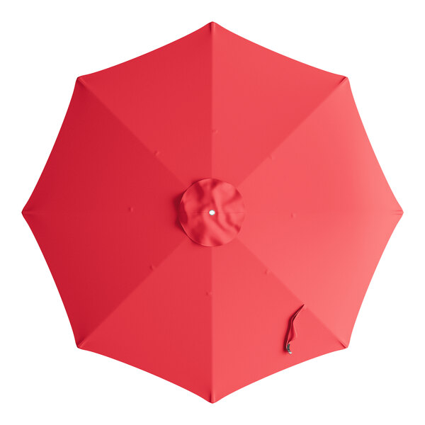 A red round umbrella canopy with a white dot on a handle.