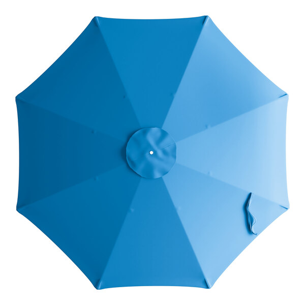 A close-up of a blue circular Lancaster Table & Seating umbrella canopy with a white circle.